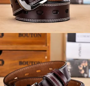 Detailed view of dark brown leather belt with white stitching and silver metal buckle