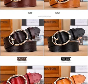 Close-up of embossed leather belts in coffee, black, and red with gold oval buckles