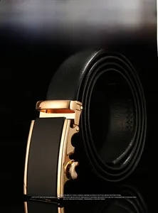 Macro shot of gold automatic belt buckle with black mirror finish and leather texture