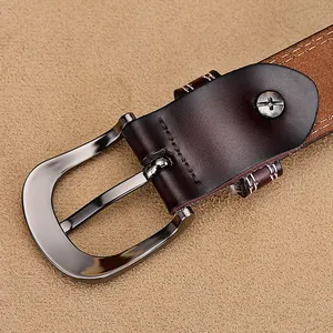 Detailed view of dark brown leather belt with gunmetal buckle and white stitching
