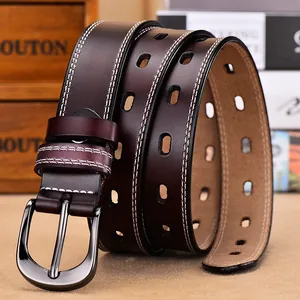 Detail of genuine leather belt showing white double stitching and polished metal buckle
