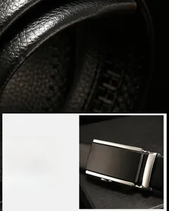 Detail of men's leather belt with textured lychee grain and silver automatic buckle