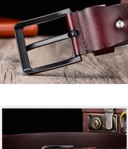 Detailed macro view of dark burgundy leather belt with matte black metal buckle and silver screws