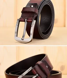 Close-up of brown leather belt with silver metal pin buckle and textured finish