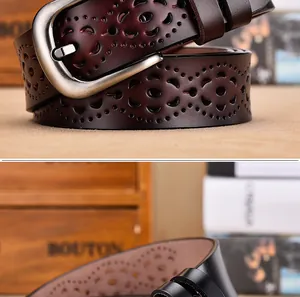 Dettaglio cintura in pelle bordeaux con motivi floreali traforati e fibbia in metallo