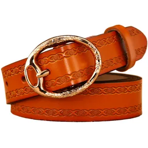 Orange embossed leather belt for women with elegant golden floral buckle on white background