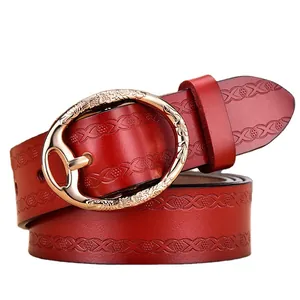 Deep red leather belt for women featuring vintage floral embossed patterns and gold buckle
