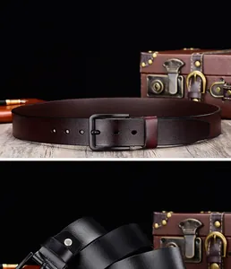 Detailed view of men's leather belts in black and brown with matte metal buckles