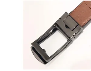 Detail of men's brown leather belt with cross pattern and matte gunmetal auto buckle
