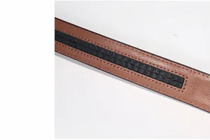 Detailed close-up of brown crosshatch leather belt with black woven texture strip