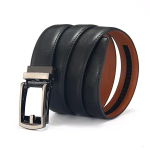 Macro shot of black Saffiano leather belt with brown lining and metal automatic buckle