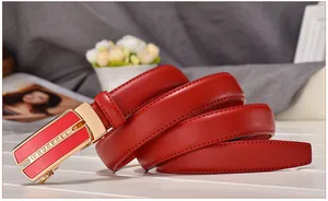 Detail of red leather belt with gold automatic buckle and sparkling rhinestones