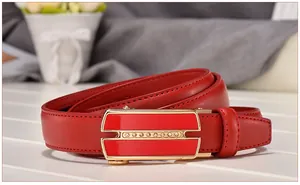 Close-up of red genuine leather belt with gold rhinestone buckle on white wooden table