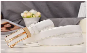 Detailed close-up of white leather belt featuring a gold buckle with sparkling rhinestones