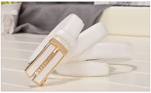 Detailed close-up of white leather belt with gold automatic buckle and rhinestone accents