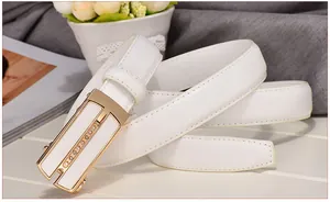 Detail of white leather belt with gold automatic buckle and 100% leather interior stamp