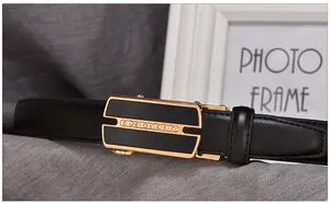 Detail of black leather business belt with gold rhinestone automatic buckle on grey fabric