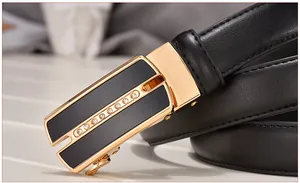 Close-up of a black leather belt with gold automatic buckle and rhinestone detailing