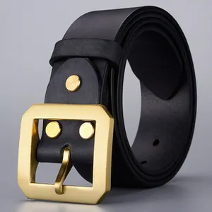 Close-up of matte black leather belt with brushed gold brass buckle and rivets