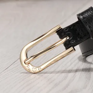 Women's thin black leather belt with a golden heart-shaped buckle and lychee texture