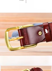 Detail of genuine leather belt showing the durable stainless steel screw and gold buckle
