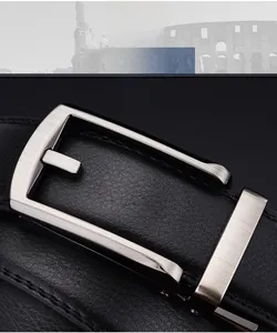 Macro detail of men's brushed alloy buckle and black leather belt with precision stitching