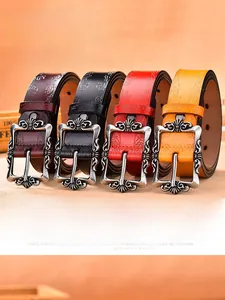Detailed close-up of embossed leather belts with vintage engraved buckles in four colors