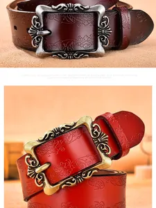 Detail of floral embossed leather belt with vintage baroque style metal buckle