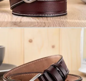 Détail d'une ceinture en cuir bordeaux avec surpiqûres blanches et boucle en argent mat
