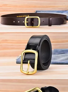 Detailed macro of genuine leather belt grain with gold metal buckle on wood background