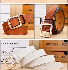 Detailed view of leather belt with gold pin buckle in brown and white colors