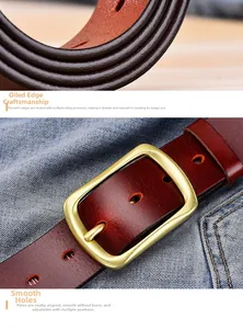 Detail of reddish-brown leather belt with brass buckle and hand-painted edges