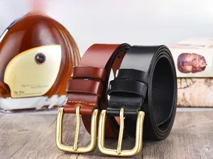 Macro detail of men's leather belts in black and brown with vintage copper pin buckles