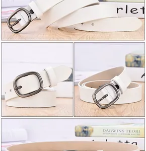 Detail of white leather belt showing retro metal round buckle and smooth finish