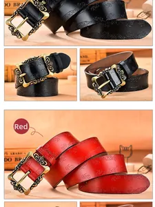 Detail of red and black leather belts with floral embossing and antique bronze buckles