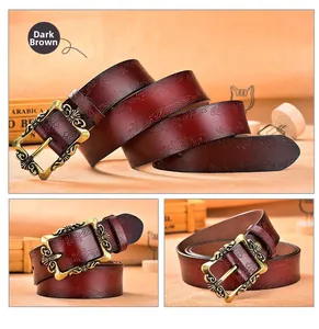 Detail of deep brown vintage leather belt with floral embossing and bronze baroque buckle