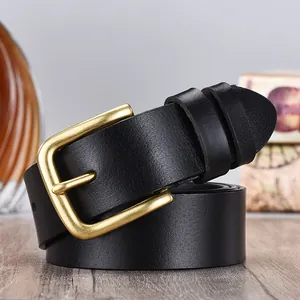 Detail of genuine leather belt with matte gold pin buckle and natural texture finish