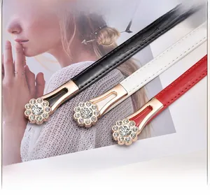 Detail of elegant butterfly buckle with sparkling rhinestones on slim decorative belts
