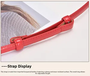 Detail of red patent leather belt with adjustable sliding loop and glossy finish