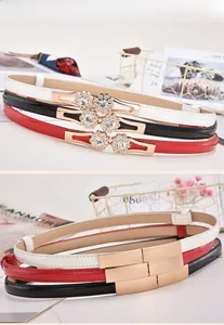 Detailed view of elegant skinny patent leather belts with rhinestone flower buckles in 3 colors