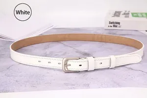 Flat lay of a white leather belt with matte silver buckle and stitching details