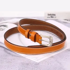 Slim orange-brown leather belt for women with white stitching and silver pin buckle