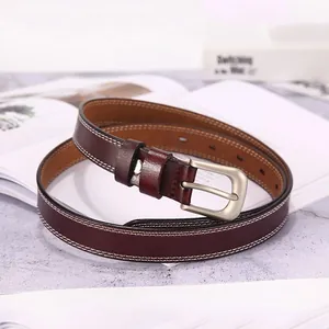 Detail of dark brown leather belt featuring white contrast stitching and silver pin buckle