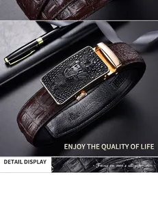 Detail view of brown crocodile texture leather belt with a 115cm gold alligator buckle