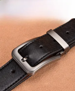 Close-up of black Saffiano leather belt with a brushed gunmetal pin buckle detail