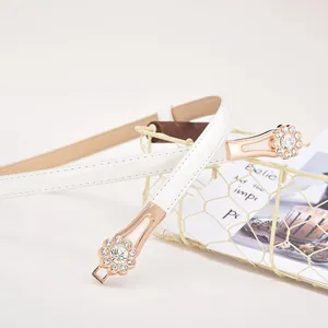 Elegant white leather belt for women featuring a rose gold rhinestone floral buckle design