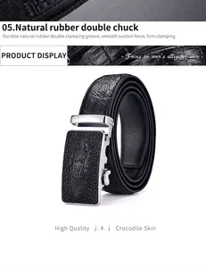 Macro shot of silver automatic buckle with 3D crocodile relief and textured leather strap