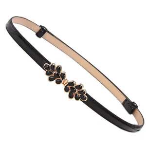 Women's thin black leather belt featuring a golden rhinestone butterfly buckle design