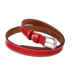 Minimalist red leather belt with silver pin buckle and contrast white stitching on white background