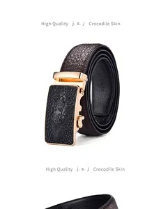 Detailed close-up of brown crocodile pattern belt with a gold-tone automatic buckle
